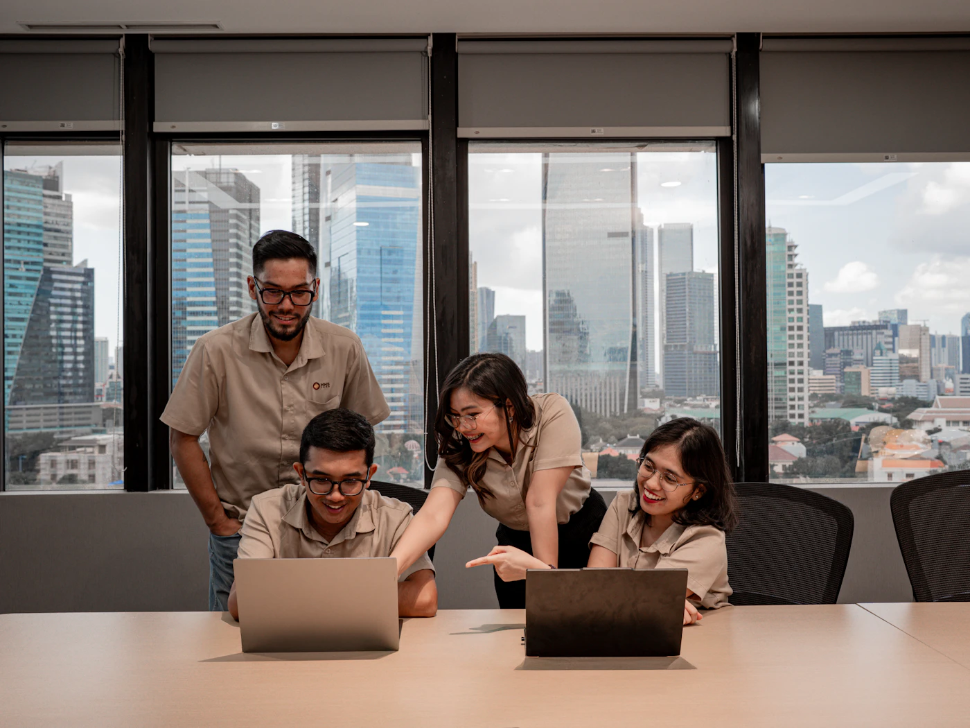 A small team working together in an office with a city view